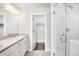 Bathroom featuring granite counters, undermount sink, white cabinets, and glass shower with floor to ceiling subway tile at 12714 E Dickenson Ave, Aurora, CO 80014