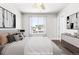 Staged bedroom featuring a comfortable bed, stylish decor, and a bright window with exterior views at 12714 E Dickenson Ave, Aurora, CO 80014