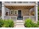 Inviting front porch with stone accents and manicured greenery at 12714 E Dickenson Ave, Aurora, CO 80014