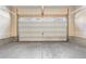 Spacious and clean empty two-car garage with concrete flooring at 12714 E Dickenson Ave, Aurora, CO 80014