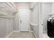Convenient laundry room with built-in shelving, washer/dryer hookups, and ample space for folding and storage at 12714 E Dickenson Ave, Aurora, CO 80014