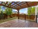 Spacious wooden deck with a pergola and a fenced yard, creating a serene outdoor living space at 713 San Juan Dr, Lafayette, CO 80026