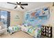 Charming bedroom featuring two beds, colorful wall art, and a ceiling fan at 713 San Juan Dr, Lafayette, CO 80026