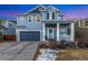 Charming blue two-story home boasting a covered front porch and a two-car garage at 713 San Juan Dr, Lafayette, CO 80026