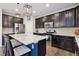 Modern kitchen featuring dark cabinets, stainless steel appliances, and a center island at 713 San Juan Dr, Lafayette, CO 80026