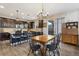 Eat-in kitchen with stainless steel appliances, dark cabinetry, and a wooden dining table at 713 San Juan Dr, Lafayette, CO 80026