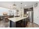 Bright, open kitchen and living area, features stainless steel appliances and dark cabinets at 713 San Juan Dr, Lafayette, CO 80026