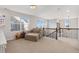 Inviting loft area with comfortable seating, natural light, and railing overlooking the staircase at 713 San Juan Dr, Lafayette, CO 80026