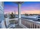 Cozy front porch offers peaceful neighborhood views at dusk, featuring white rocking chairs at 713 San Juan Dr, Lafayette, CO 80026