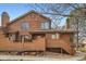 Exterior rear view of a home with a back deck and wood facade at 9295 W 80Th Pl # A, Arvada, CO 80005