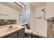 Updated bathroom featuring a stylish vanity, decorative tile, and a walk-in shower at 9295 W 80Th Pl # A, Arvada, CO 80005
