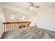 Second story bedroom boasts skylights, a ceiling fan, plush carpet, and stair access at 9295 W 80Th Pl # A, Arvada, CO 80005