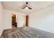 Bedroom with neutral carpet, ceiling fan, and doorway leading to en-suite bath at 9295 W 80Th Pl # A, Arvada, CO 80005