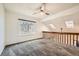 Upstairs bedroom offers natural light with skylights, a ceiling fan, and plush carpet at 9295 W 80Th Pl # A, Arvada, CO 80005