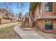 Beautiful exterior view of a home with a wood facade and outdoor sidewalk at 9295 W 80Th Pl # A, Arvada, CO 80005
