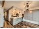 Modern kitchen with kitchen island, updated appliances, custom cabinets, and wood floors at 9295 W 80Th Pl # A, Arvada, CO 80005