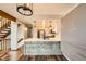 Modern kitchen with wood floors, kitchen island, updated appliances, and white subway tile at 9295 W 80Th Pl # A, Arvada, CO 80005