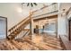 Spacious living room featuring wood floors, staircase, and an open view into the kitchen at 9295 W 80Th Pl # A, Arvada, CO 80005