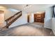 Spacious living area features a staircase, built-in shelving, and neutral carpeting at 9295 W 80Th Pl # A, Arvada, CO 80005