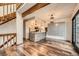 Open living space with wood floors, a kitchen island, and stylish pendant lighting at 9295 W 80Th Pl # A, Arvada, CO 80005