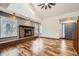 Spacious living room featuring wood floors, fireplace, vaulted ceilings, and a ceiling fan at 9295 W 80Th Pl # A, Arvada, CO 80005