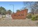 Landmark stone community sign with manicured landscaping and trees at 9295 W 80Th Pl # A, Arvada, CO 80005