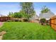 Expansive backyard featuring lush green grass and a privacy fence provides a serene outdoor space at 6342 Marshall St, Arvada, CO 80003