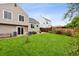 Spacious backyard with a grassy lawn, mature trees, and a patio area offers room to roam at 6342 Marshall St, Arvada, CO 80003