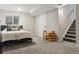 Finished basement bedroom with a bed, window, and a set of stairs leading to the main level at 6342 Marshall St, Arvada, CO 80003