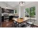 Bright dining space with hardwood floors, stylish lighting, adjacent to kitchen with window views at 6342 Marshall St, Arvada, CO 80003