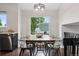 Well-lit dining area with modern lighting, hardwood floors, and large window at 6342 Marshall St, Arvada, CO 80003