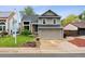 Charming two-story home with a well-maintained lawn, inviting entrance and two car garage at 6342 Marshall St, Arvada, CO 80003
