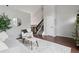 Cozy living room showcasing hardwood floors, neutral decor, staircase and vaulted ceiling at 6342 Marshall St, Arvada, CO 80003