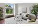 Comfortable living room featuring a large window and view of mature landscaping at 6342 Marshall St, Arvada, CO 80003