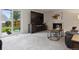 Spacious living room with a fireplace, large TV, neutral tones, and sliding glass doors to the backyard at 6342 Marshall St, Arvada, CO 80003
