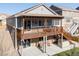 Multi-level deck overlooking the backyard, with a stone exterior, providing ample space for outdoor entertainment at 8048 Grady Cir, Castle Rock, CO 80108