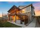 Multi-level backyard deck featuring a pergola, string lights, and a hot tub for relaxation and entertainment at 8048 Grady Cir, Castle Rock, CO 80108