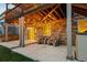 Covered patio with stone accents and outdoor seating, creating a cozy and inviting space at 8048 Grady Cir, Castle Rock, CO 80108