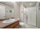 Clean bathroom featuring a walk-in shower with glass doors and a vanity sink at 8048 Grady Cir, Castle Rock, CO 80108