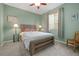 Bedroom with light green walls, a ceiling fan, and a window with blinds and curtains at 8048 Grady Cir, Castle Rock, CO 80108