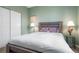 Bedroom featuring light green walls, neutral carpet, and a full sized bed at 8048 Grady Cir, Castle Rock, CO 80108