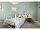 Bedroom featuring light green walls, neutral carpet, a twin bed with flower comforter at 8048 Grady Cir, Castle Rock, CO 80108