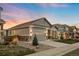 Beautiful single-story home with a well-maintained lawn and inviting curb appeal at dusk at 8048 Grady Cir, Castle Rock, CO 80108