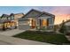 Inviting single-story home features a two-car garage, stone accents, and a lovely front yard at 8048 Grady Cir, Castle Rock, CO 80108