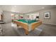 Finished basement with pool table, foosball, and ample lighting and natural light at 8048 Grady Cir, Castle Rock, CO 80108
