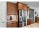 Kitchen with stainless steel refrigerator, granite countertops, and wood cabinetry at 8048 Grady Cir, Castle Rock, CO 80108