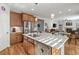 Open concept kitchen features granite island, stainless steel appliances, and hardwood floors at 8048 Grady Cir, Castle Rock, CO 80108