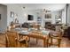 Open floor plan with dining area leading to a living room with fireplace and comfortable seating at 8048 Grady Cir, Castle Rock, CO 80108