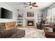 Cozy living room with stone fireplace, hardwood floors, and comfortable seating arrangement at 8048 Grady Cir, Castle Rock, CO 80108