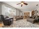 Spacious living room with hardwood floors, large windows, and a view of the kitchen at 8048 Grady Cir, Castle Rock, CO 80108